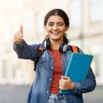 indian-student-giving-thumbs-up-campus-lady-books-gives-portraying-approval-positivity-educational-environment-314905008